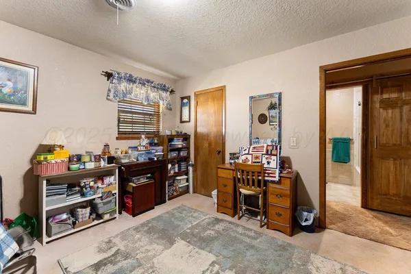 a view of a yard in front of a house with large trees