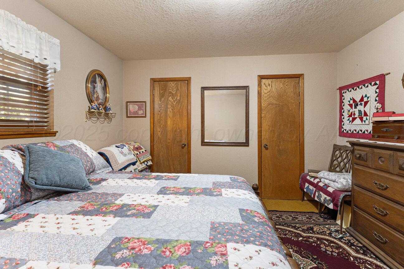 148 Buffalo Trail Fritch, TX 79036 - Photo 38 of 81 a bedroom with a bed and wooden floor