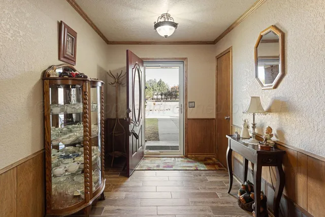 a view of a hallway with wooden floor and entryway