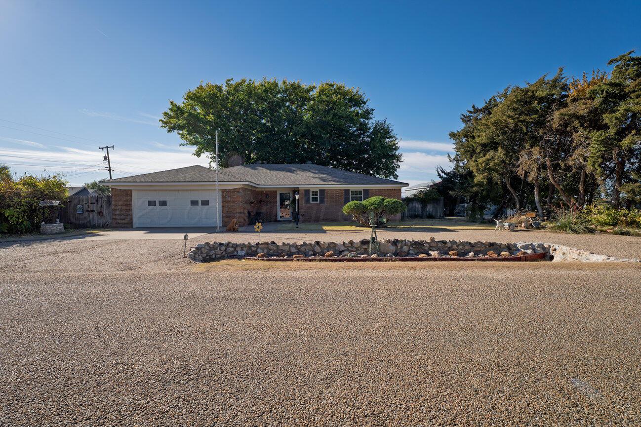 148 Buffalo Trail Fritch, TX 79036 - Photo 80 of 81 a front view of a house with a yard and garage