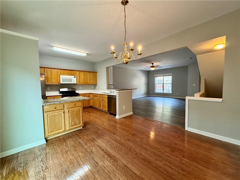 3980 Howell Park Road Duluth, GA 30096 - Photo 12 of 34 a kitchen with granite countertop a stove top oven and cabinets