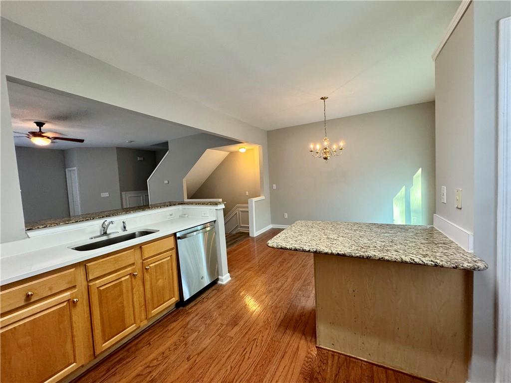 3980 Howell Park Road Duluth, GA 30096 - Photo 15 of 34 a kitchen with granite countertop wooden cabinets and a granite counter tops