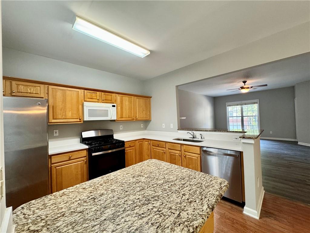 3980 Howell Park Road Duluth, GA 30096 - Photo 16 of 34 a kitchen with granite countertop a stove top oven and sink