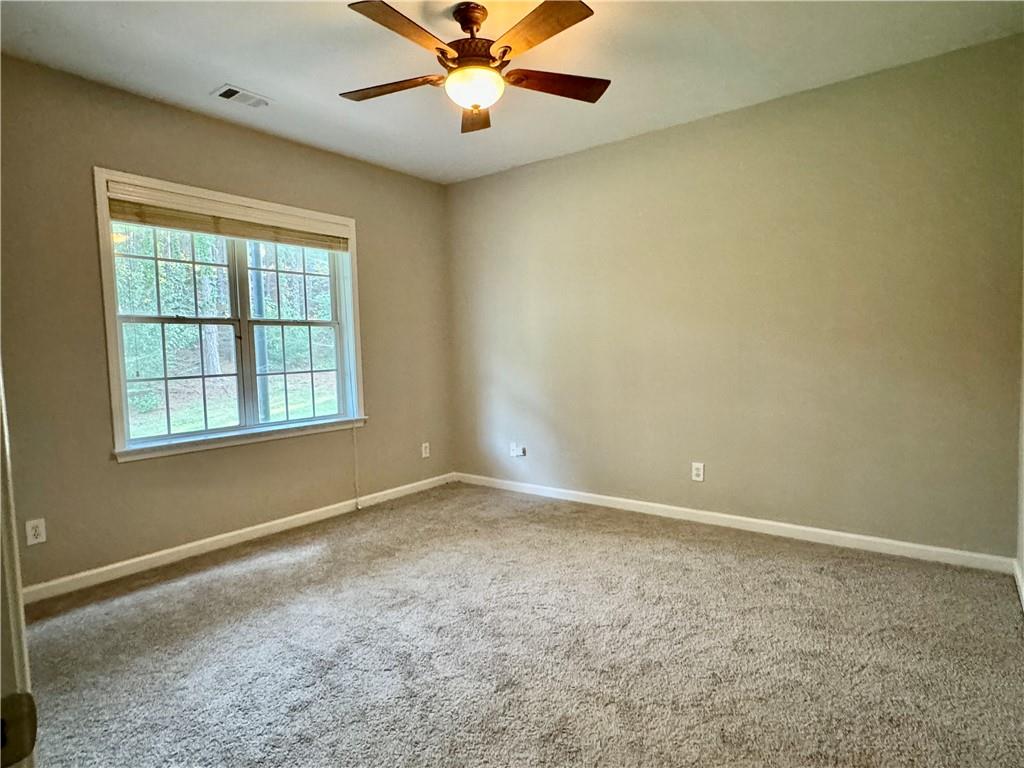 3980 Howell Park Road Duluth, GA 30096 - Photo 24 of 34 an empty room with a window and a fan