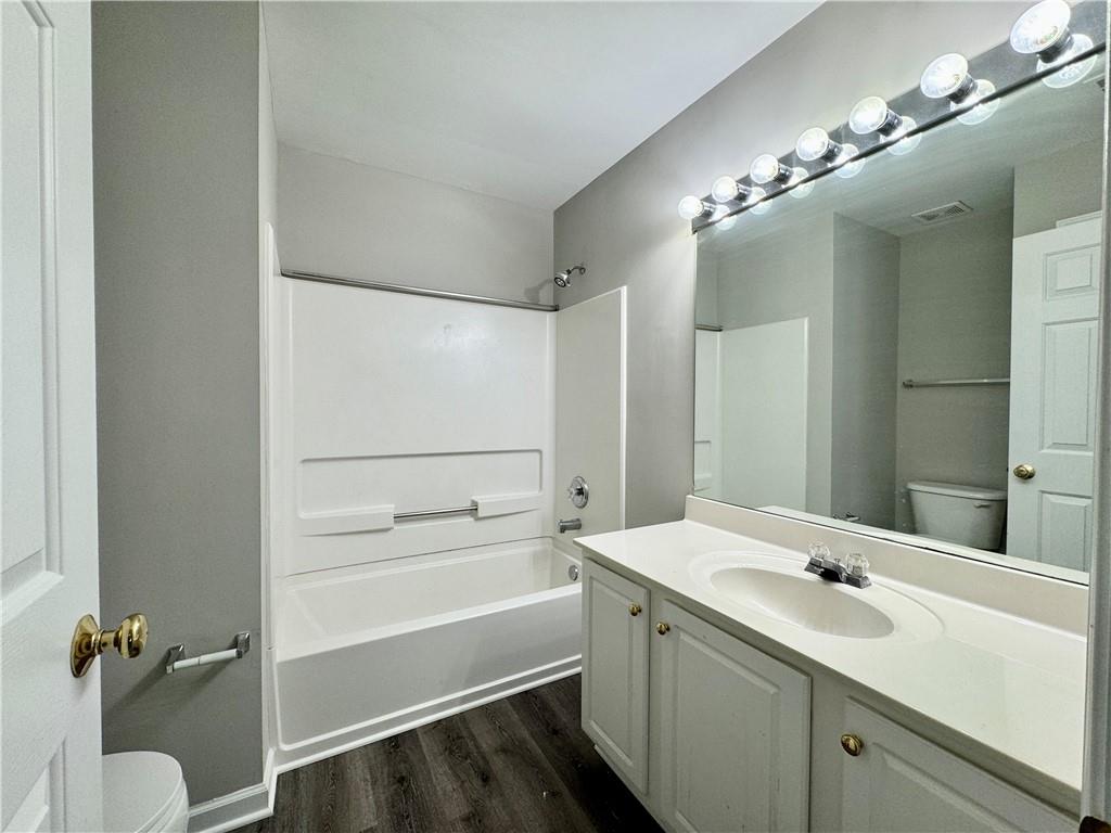 3980 Howell Park Road Duluth, GA 30096 - Photo 28 of 34 a bathroom with a bathtub shower sink vanity and toilet