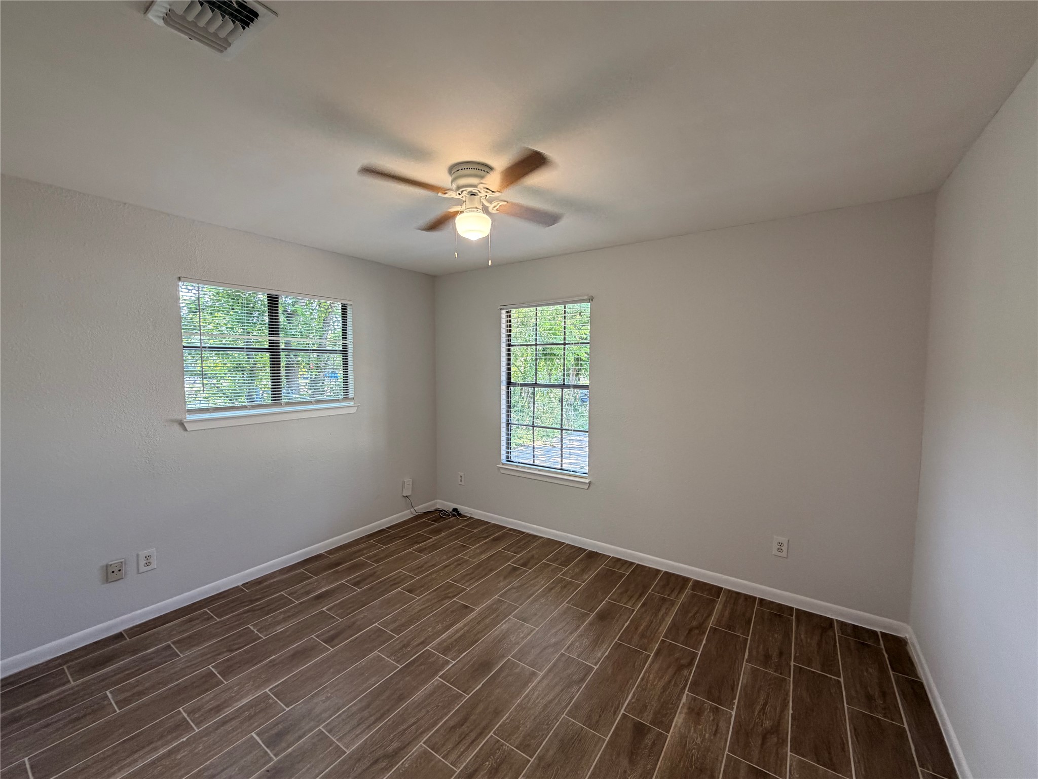 604 Gaylor Street, Unit B Austin, TX 78752 - Photo 5 of 5 Wood-look tiled flooring and ample natural light define this cozy interior space.