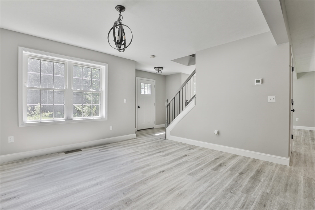 46 Gray Road Templeton, MA 01468 - Photo 3 of 33 a view of an empty room with wooden floor and a window