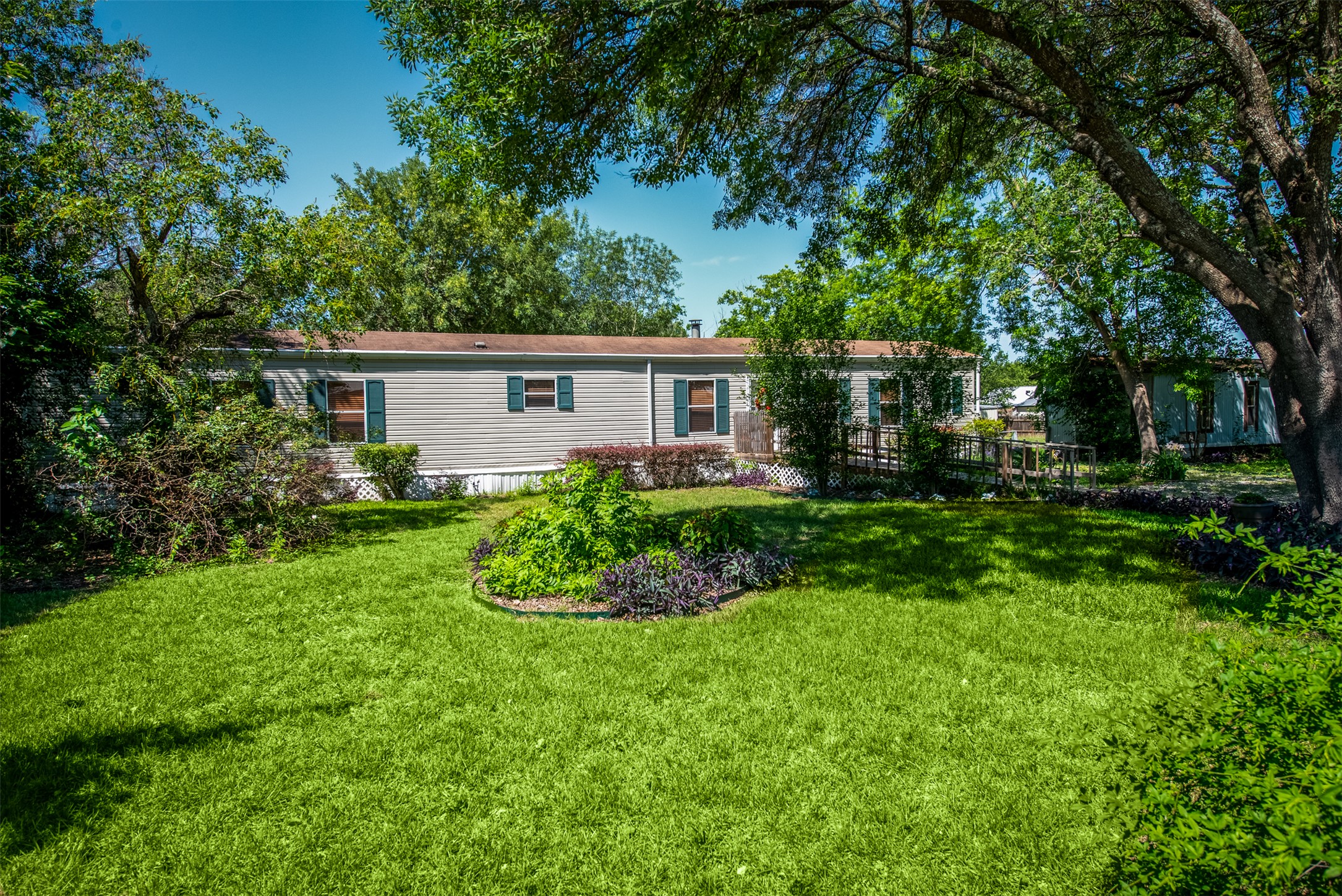 258 Quail Ridge Drive Kyle, TX 78640 - Photo 2 of 11 Expansive front lawn with mature trees and established landscaping