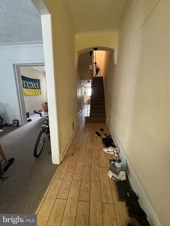 a view of entryway and hall with wooden floor