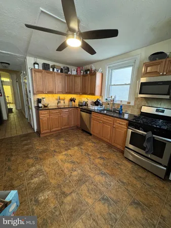 a kitchen with a stove a sink and a refrigerator