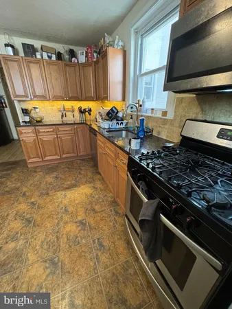 a kitchen with granite countertop a stove and a sink
