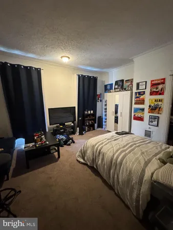 a bed room with a bed and a television