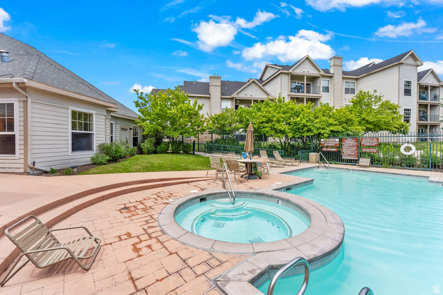 900 Bitner Road, Unit K25 Park City, UT 84098 - Photo 33 of 35 Outdoor amenity space featuring a swimming pool, integrated spa, and brick paver deck