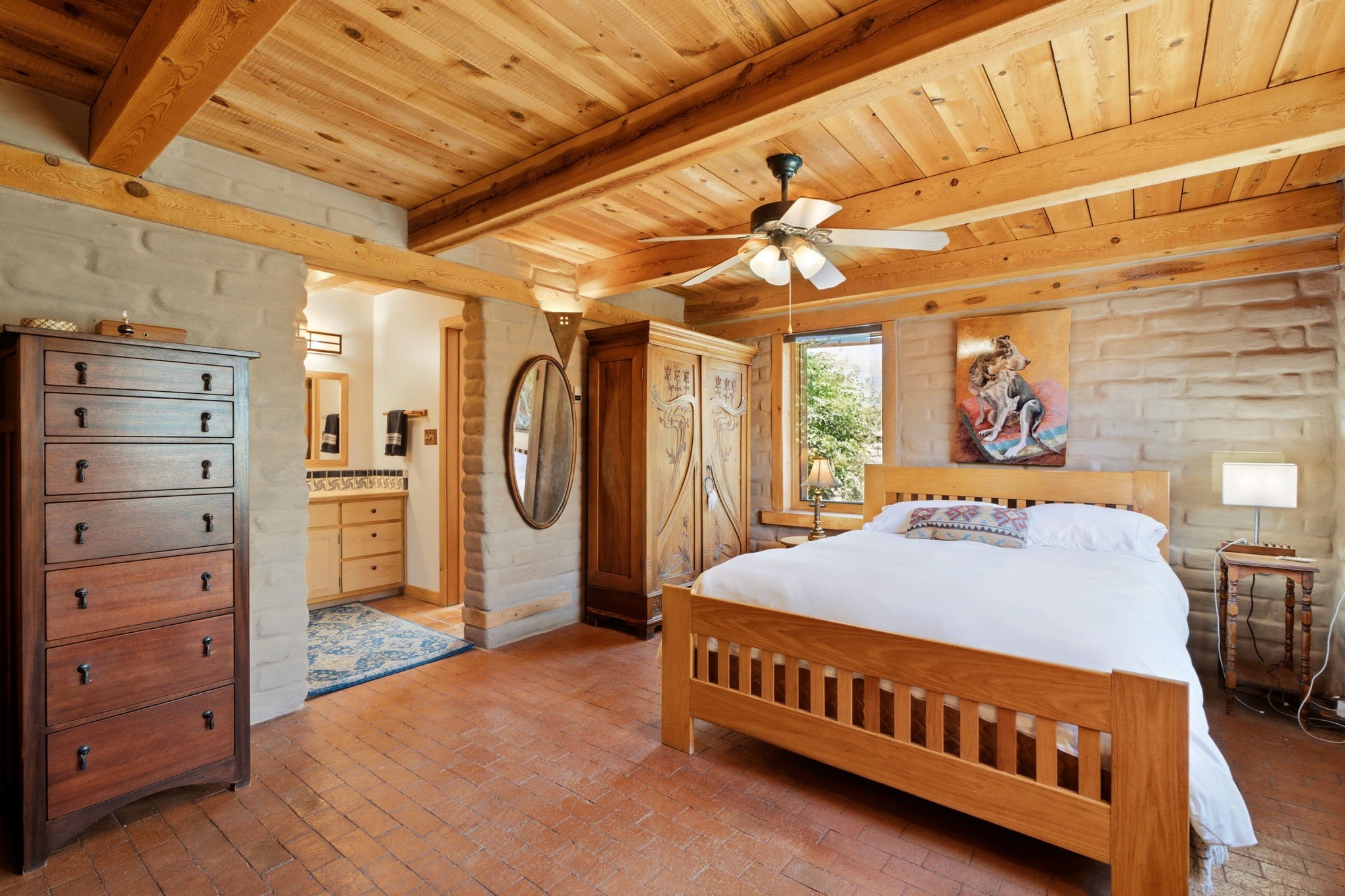 22 Mimosa Road Santa Fe, NM 87508 - Photo 15 of 51 Exposed adobe walls in primary bedroom, beamed ceilings and brick floors