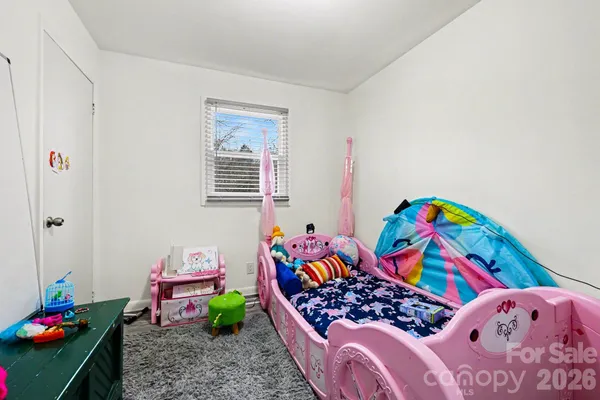 a bedroom with bed and ceiling fan