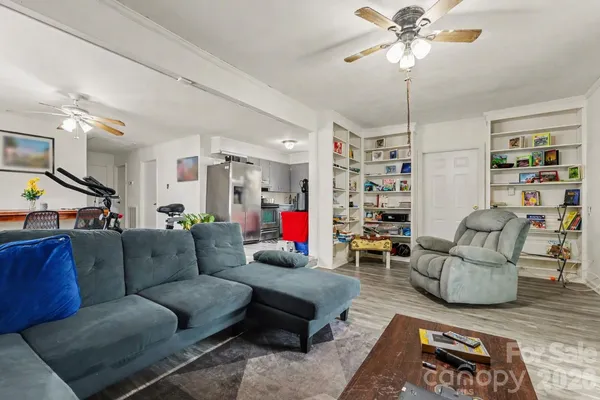 a living room with furniture and wooden floor