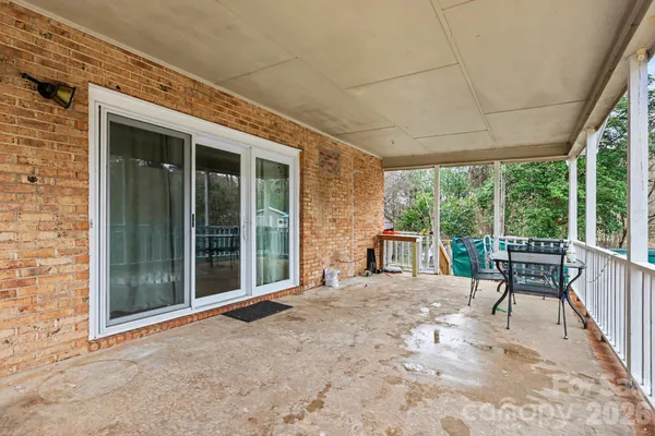 a balcony with furniture and a gate
