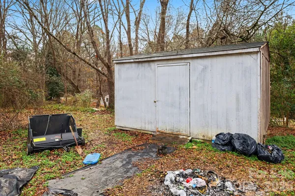 a backyard of a house with a table and chairs