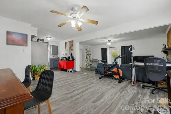 a living room with furniture and a gym cycle