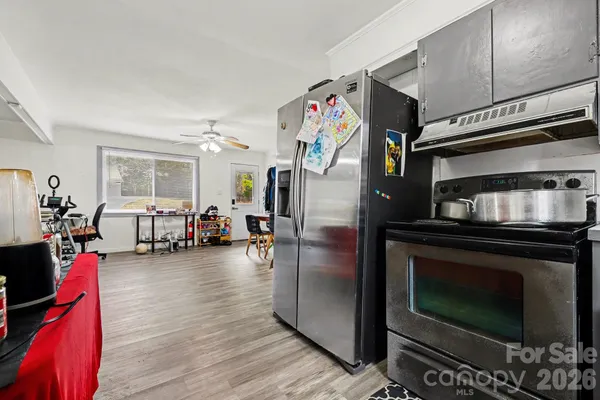 a kitchen with stainless steel appliances kitchen island granite countertop a stove and cabinets