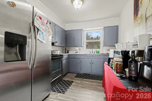 a kitchen with stainless steel appliances kitchen island granite countertop a refrigerator stove and sink
