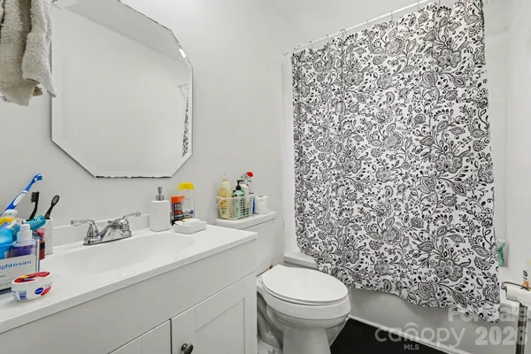 a bathroom with a sink toilet and a mirror