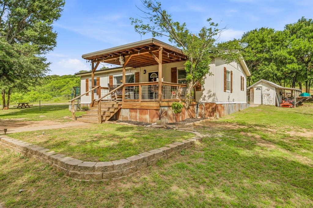 151 High Point Road Weatherford, TX 76088 - Photo 4 of 40 a view of a house with a yard
