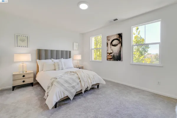 a bedroom with a bed and a lamp