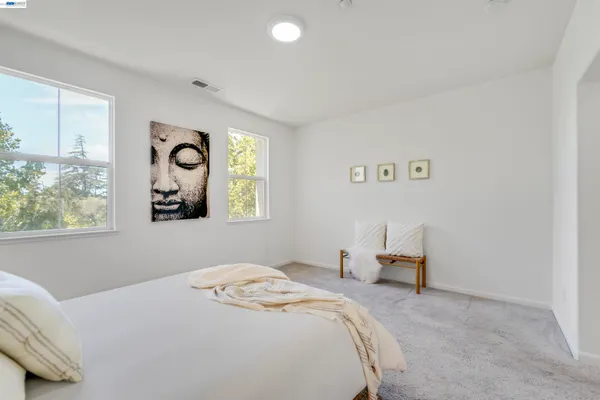 a bedroom with a bed and a lamp