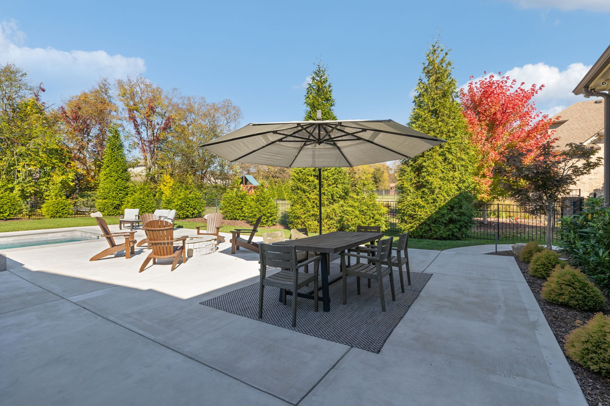 2772 Cabin Run Bridge Road Thompson's Station, TN 37179 - Photo 29 of 98 a view of a patio with chairs and table under an umbrella