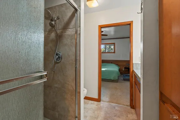a bathroom with a glass shower door