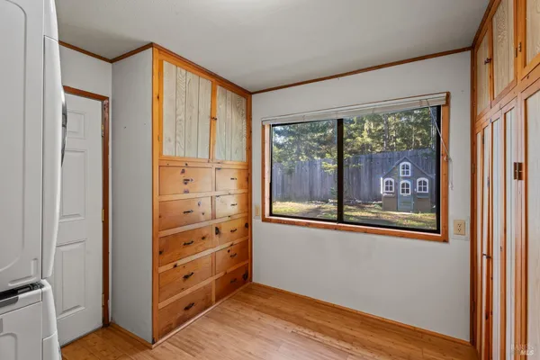 a view of a hallway with wooden floor and windows