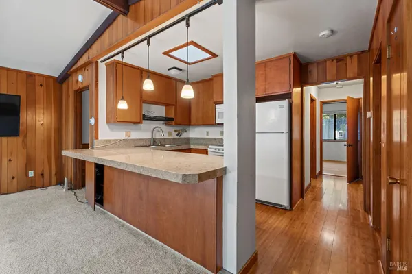 a kitchen with stainless steel appliances granite countertop a refrigerator a sink and a stove