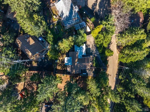 an aerial view of a house with a yard and garden
