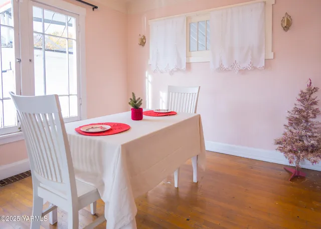 a dining room with furniture and wooden floor