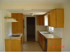 2430 Lisa Melbourne, FL 32935 - Photo 8 of 11 a kitchen that has a sink and a stove in it