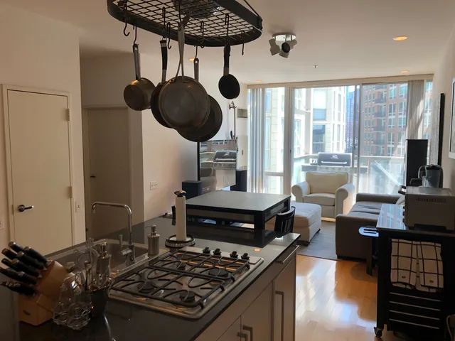 a kitchen with a stove and a wooden floor