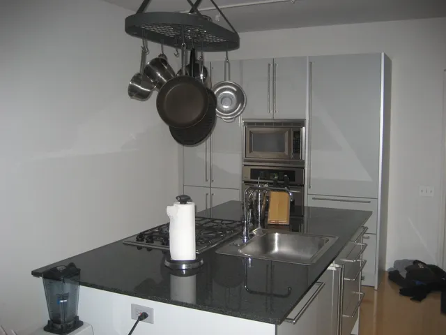 a kitchen with a table and a stove top oven