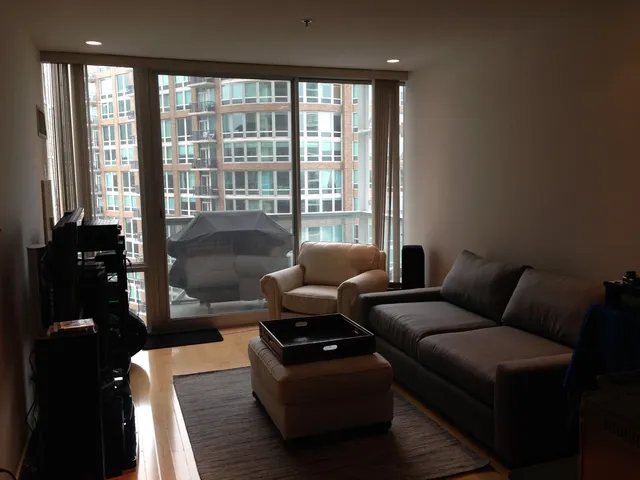 a living room with furniture and a floor to ceiling window