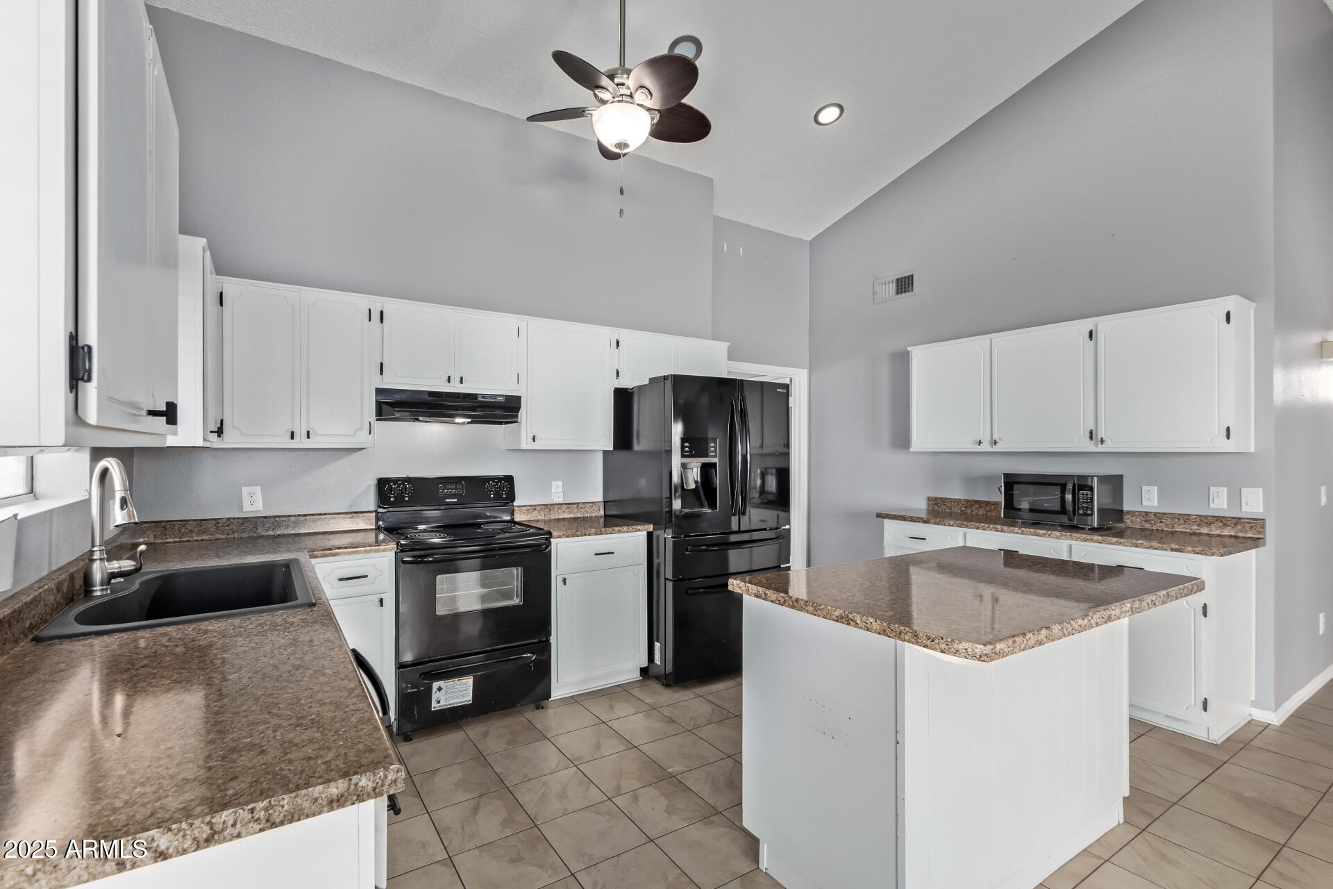 9266 East Quarterline Road Mesa, AZ 85207 - Photo 12 of 31 a kitchen with granite countertop a stove sink and refrigerator