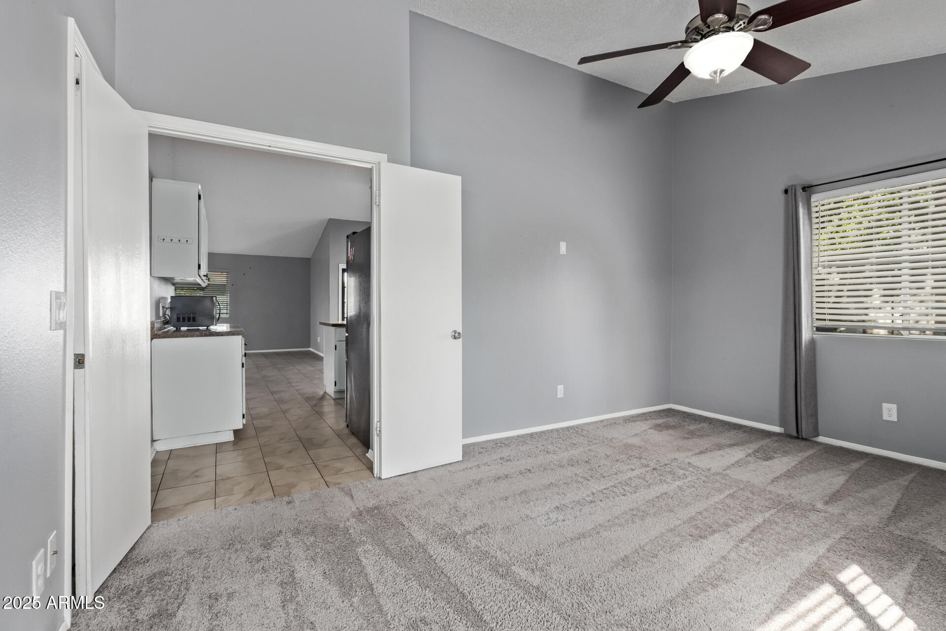 9266 East Quarterline Road Mesa, AZ 85207 - Photo 16 of 31 a view of a kitchen with a refrigerator and a ceiling fan