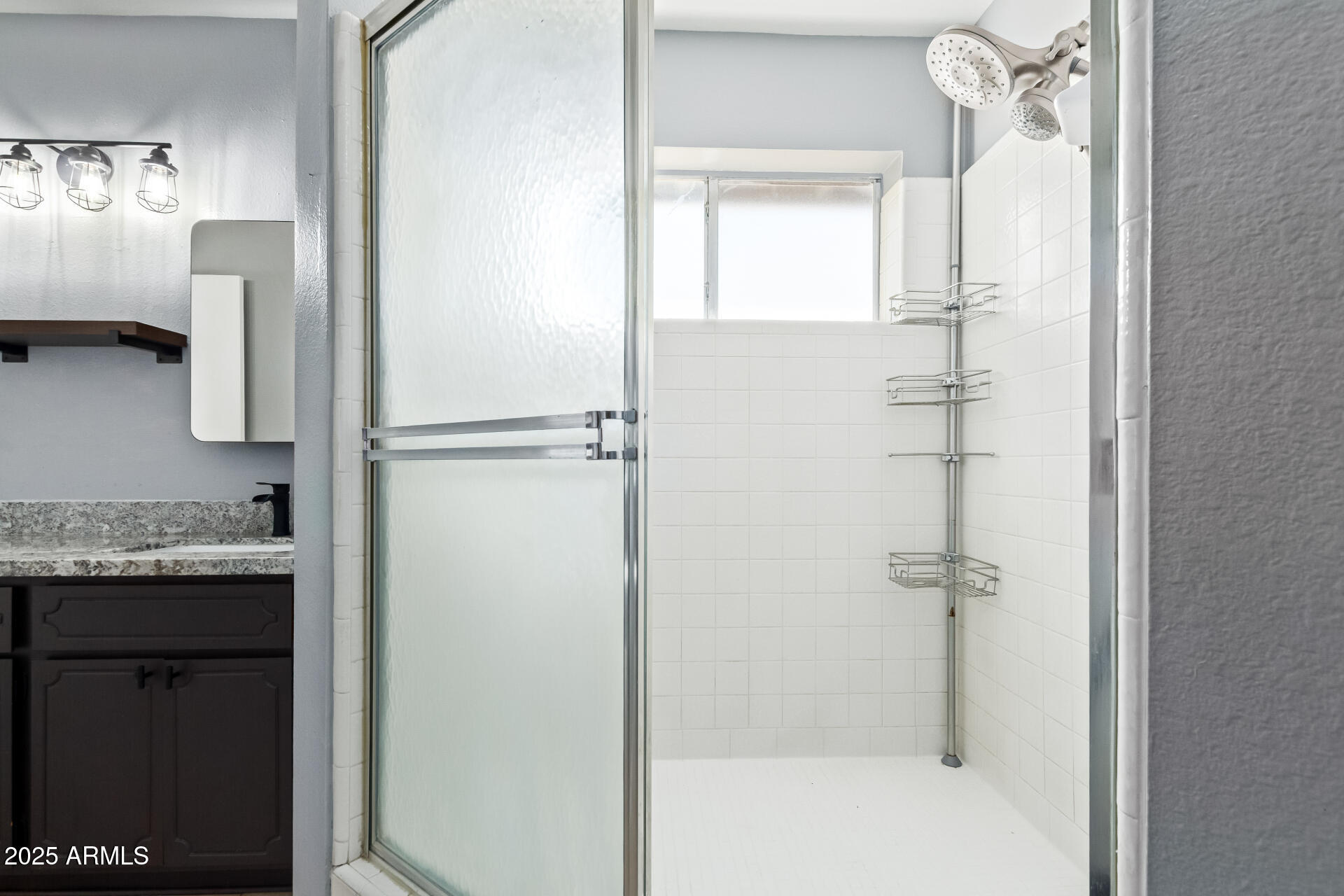 9266 East Quarterline Road Mesa, AZ 85207 - Photo 19 of 31 a bathroom with a granite countertop shower a mirror and a sink