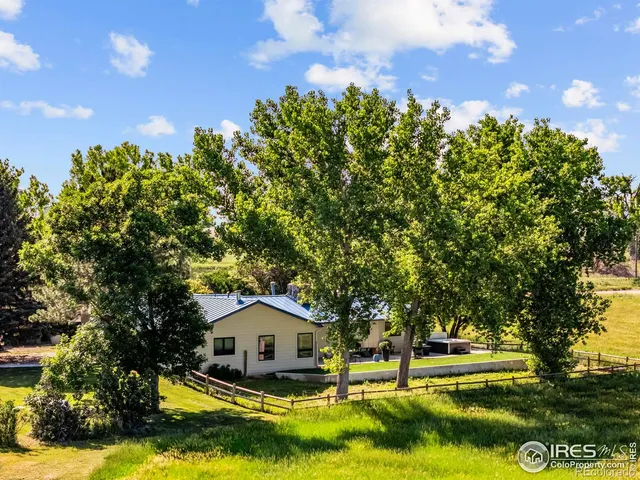 a view of a house with swimming pool and sitting area