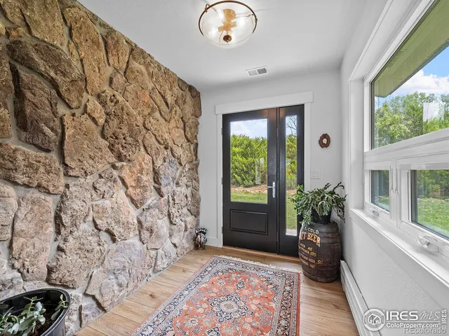 a living room with a bed and a potted plant