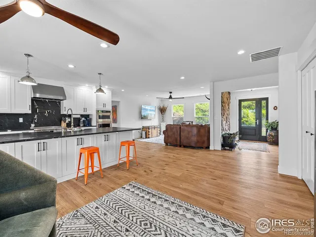 a view of kitchen with kitchen island dining table and wooden floor