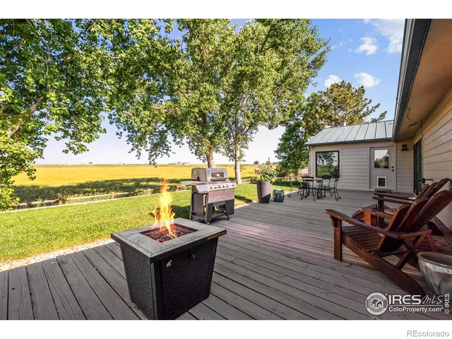 a view of a patio with table and chairs potted plants with wooden fence