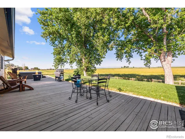 a view of swimming pool with outdoor seating and lake view