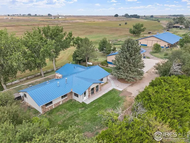 an aerial view of a house with garden space and ocean view