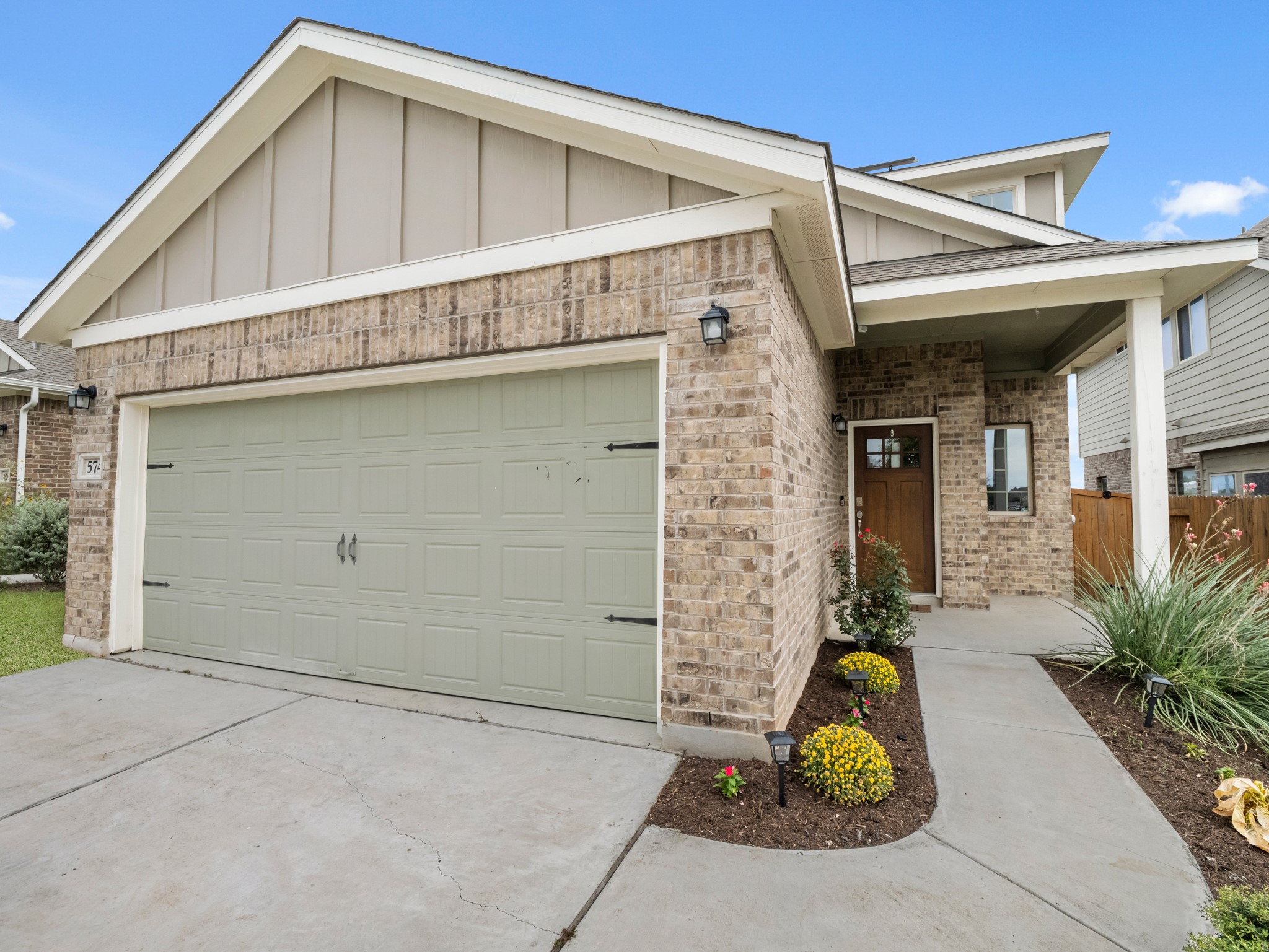 574 Nautical Loop Kyle, TX 78640 - Photo 1 of 23 A welcoming brick facade with a prominent garage and inviting entry.