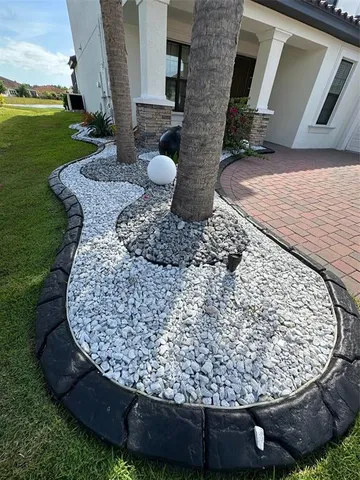a view of a house with a yard and potted plants